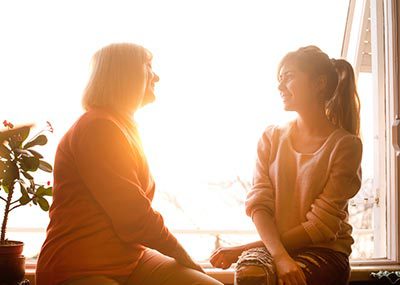 two women talk together about agencies like Lifetime Adoption