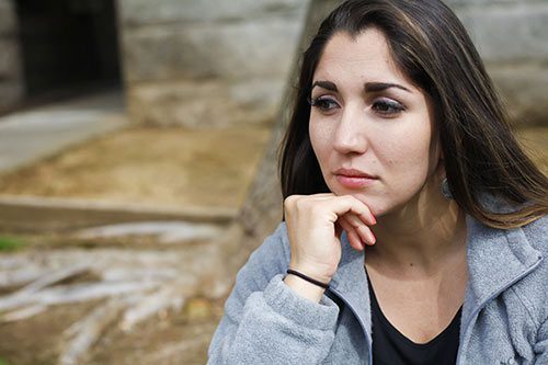 Woman sitting in a park, deep in thought