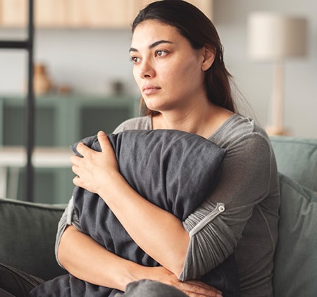 woman who has chosen adoption for her child postpartum holding pillow